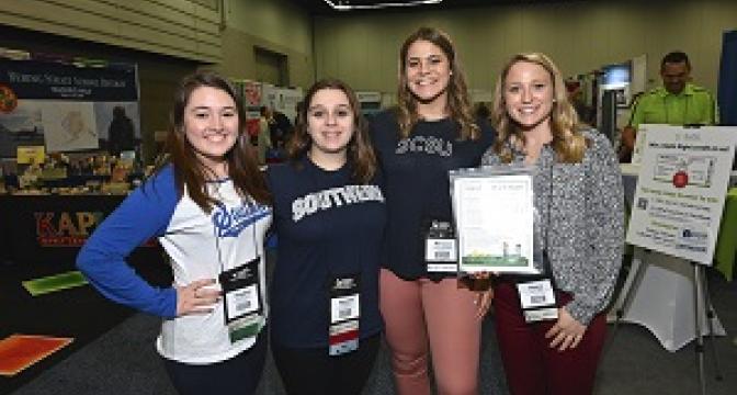 Group of female students at Convention wearing College/University shirts